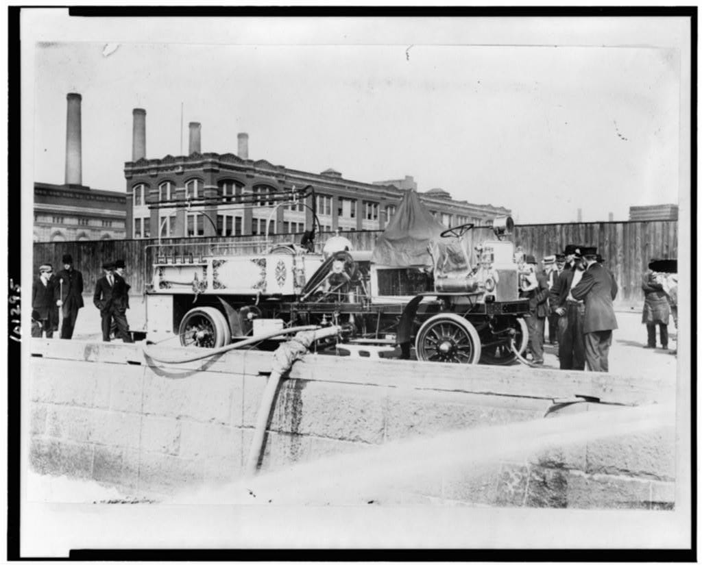 From Library of Congress: "Fire engine with initials FDNY, being filled with water, spectators standing by." c. 1911